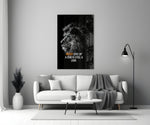 Close-up detail of B&W lion with quote behind glass