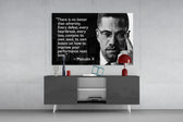 Words of Malcolm X glass wall art catching light to reveal its painted detail