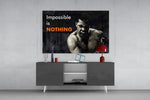 Muhammad Ali Impossible Is Nothing glass wall art catching light to reveal its painted contrast