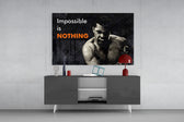 Muhammad Ali Impossible Is Nothing glass wall art catching light to reveal its painted contrast