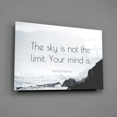 Close-up detail of misty coastline with quote behind glass