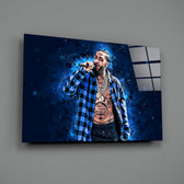 Close-up detail of Nipsey on stage in navy nebula behind glass