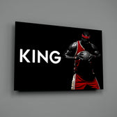 Close-up detail of LeBron with ball and King typography behind glass