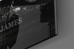 LeBron James Defy the Odds glass wall art catching light to reveal its painted typography