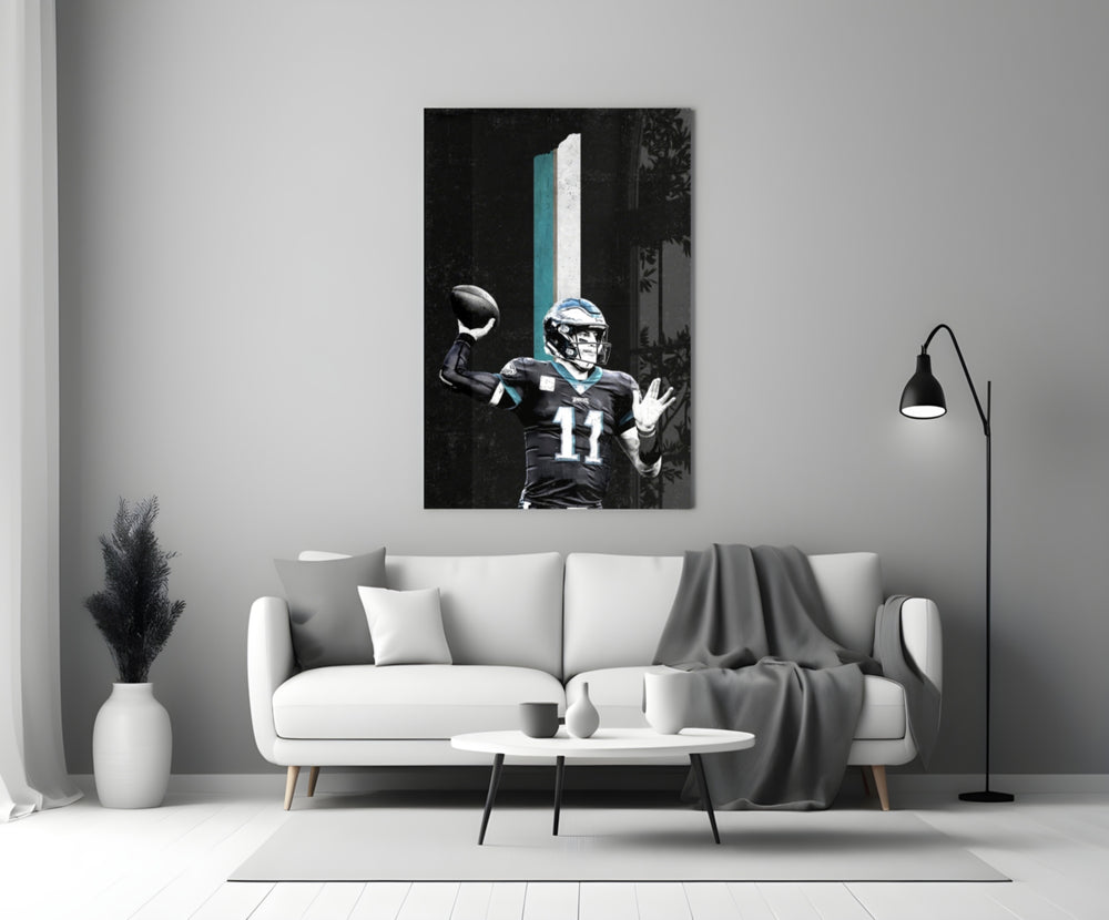 Close-up detail of Carson Wentz throwing pose behind glass