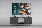 Joker glass wall art catching light to reveal its painted droplets