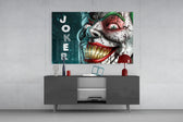 Joker glass wall art catching light to reveal its painted droplets
