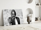 Close-up detail of John Wick ink portrait behind glass