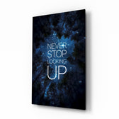 Never Stop glass wall art in a moody bedroom