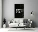 Close-up detail of Don't Quit Do It typography behind glass