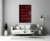 Close-up detail of scarlet Eat Lift Sleep Repeat typography behind glass