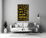 Close-up detail of saffron Eat Lift Sleep Repeat typography behind glass