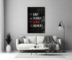 Close-up detail of Eat Sleep Gym Repeat icon list behind glass