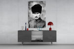 Atatürk glass wall art catching light to reveal its painted kalpak