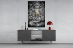 Ganesha glass wall art catching light to reveal its painted gold