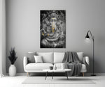 Close-up detail of stone-and-gold Ganesha behind glass