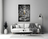Close-up detail of stone-and-gold Ganesha behind glass