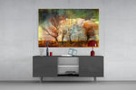 Autumn Trees glass wall art catching light to reveal its painted canvas