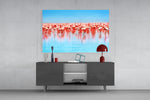 Flamingos glass wall art catching light to reveal its painted reflection