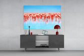 Flamingos glass wall art catching light to reveal its painted reflection