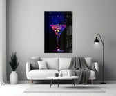 Close-up detail of cobalt-magenta neon martini behind glass