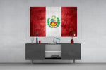 Flag of Peru glass wall art catching light to reveal its painted wreath