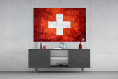 Flag of Switzerland glass wall art catching light to reveal its painted cross