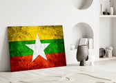 Close-up detail of grunge Myanmar flag behind glass