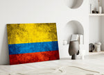 Close-up detail of grunge Colombian tricolor behind glass