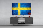 Flag of Sweden glass wall art catching light to reveal its painted stone-grunge