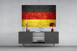 Flag of Germany glass wall art catching light to reveal its painted stone-grunge