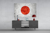 Flag of Japan glass wall art catching light to reveal its painted stone-grunge
