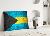 Close-up detail of rough-stone Bahamas flag behind glass