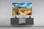 Cactuses glass wall art catching light to reveal its painted desert tones