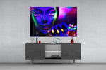 Neon Woman glass wall art catching light to reveal its painted UV pigments