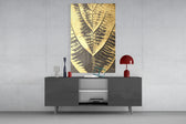 Golden Leaf glass wall art catching light to reveal its painted gilded foil