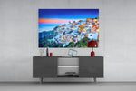 Santorini glass wall art catching light to reveal its painted sunset tones