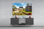 Small Village glass wall art catching light to reveal its painted heritage tones