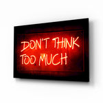 Don't Think Too Much glass wall art in a modern creative loft