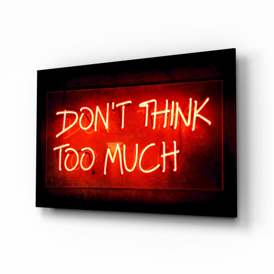 Don't Think Too Much glass wall art in a modern creative loft
