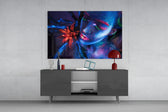 Woman glass wall art catching light to reveal its painted UV pigments