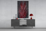 Areca Bunch glass wall art catching light to reveal its painted crimson frond