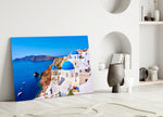 Close-up detail of Oia blue-dome chapels behind glass