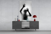 Loneliness glass wall art catching light to reveal its painted silhouette