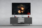 Gambler's Guns glass wall art catching light to reveal its painted gold tones