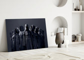 Close-up detail of hooded coven robes behind glass