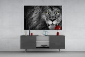 Lion glass wall art catching light to reveal its painted selective amber eyes