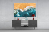 Waves glass wall art catching light to reveal its painted shoreline tones