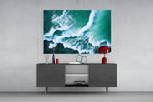 Waves glass wall art catching light to reveal its painted emerald tides