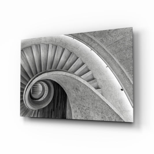 Spiral staircase concrete cinematic glass wall art above leather chair in designer office